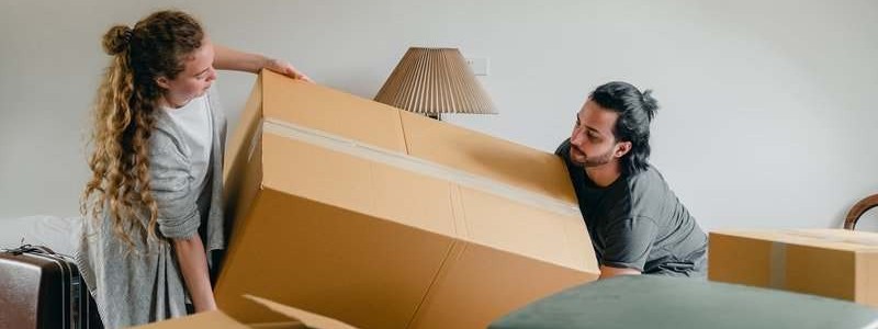 young couple trying to move a heavy item