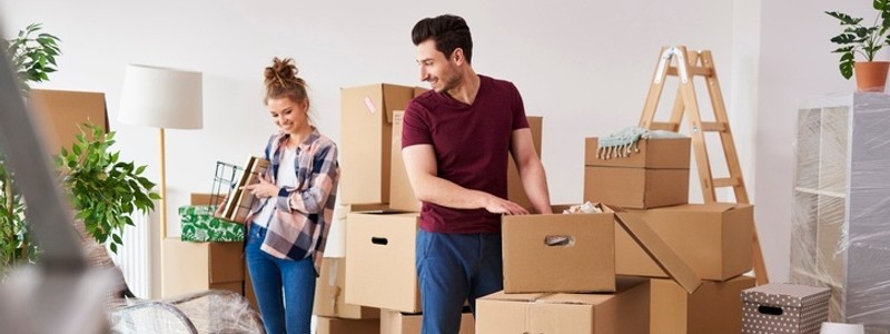 young couple packing their household for a relocation