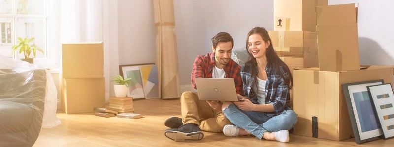 young couple searching for something on a laptop
