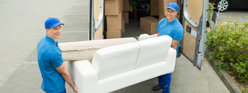 young professionals loading furniture of a truck