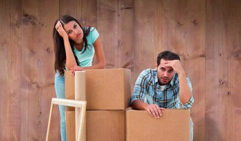couple looking stressed inside of their new house