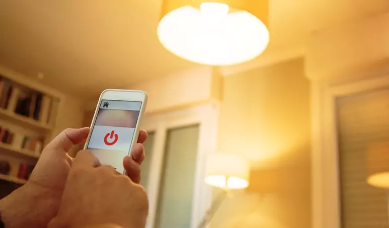 cropped picture of a person switching light with a mobile