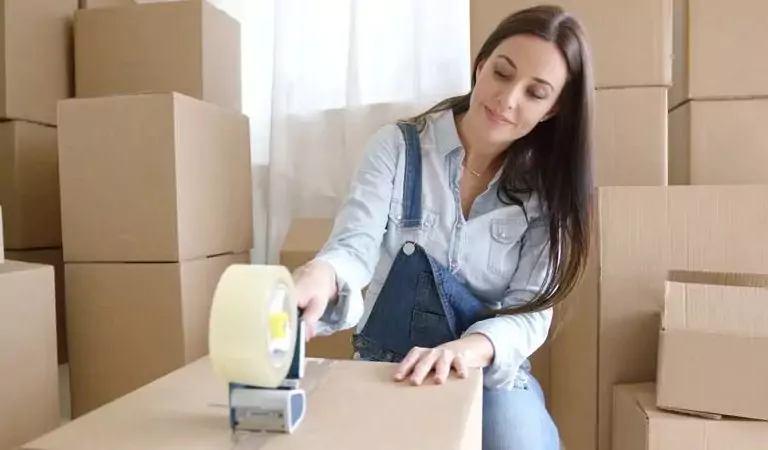 woman packing up a cardboard box