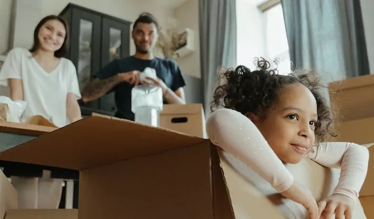 young couple inside of a new house with their daughter