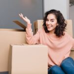 Woman is looking super excited with house moving boxes