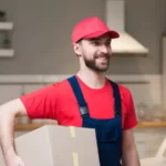 young professional with a cardboard box during a moving job