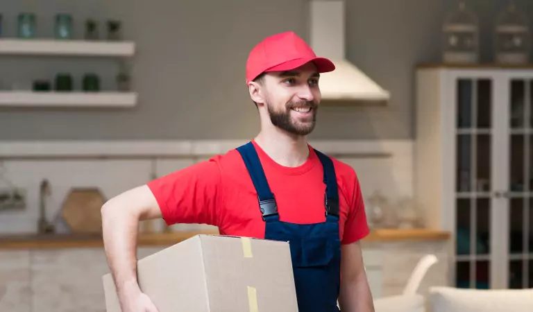 young professional with a cardboard box during a moving job