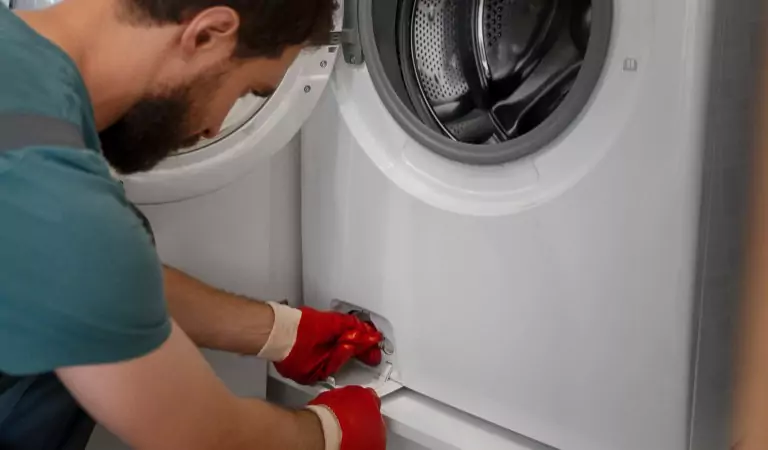 young man preparing a washing machine to move