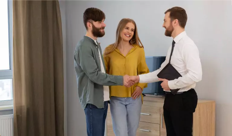 couple inside of their new house with their property manager