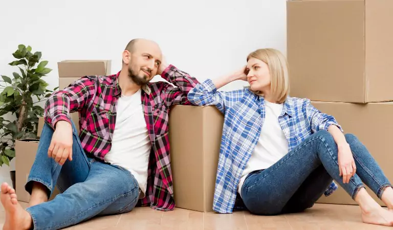 couple looking worried inside of a house