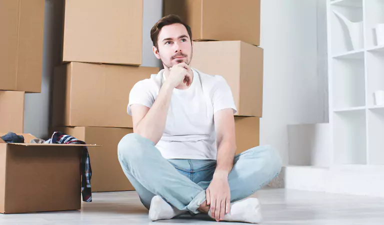young man sitting on the floor and thinking about something