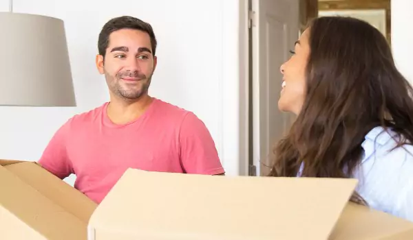 couple with some cardboard boxes preparing for a move