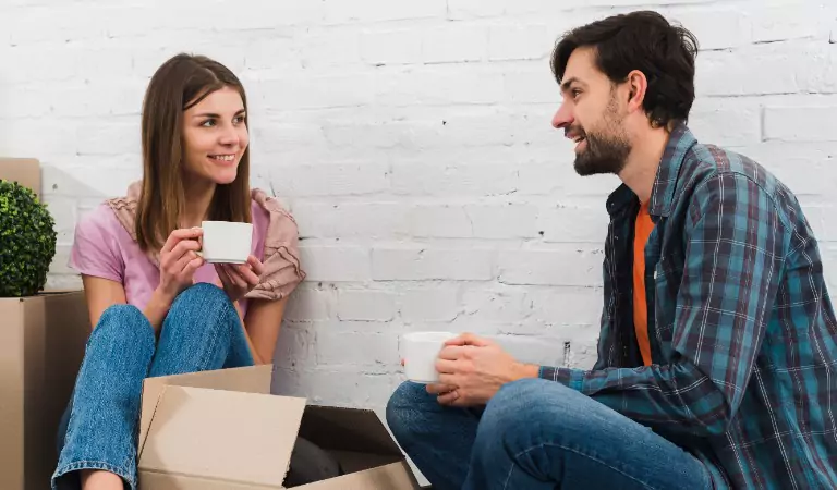 couple sitting inside of house and enjoying coffee